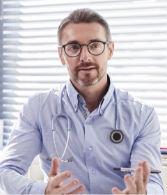 Medical doctor with stethoscope explaining addiction treatment protocols