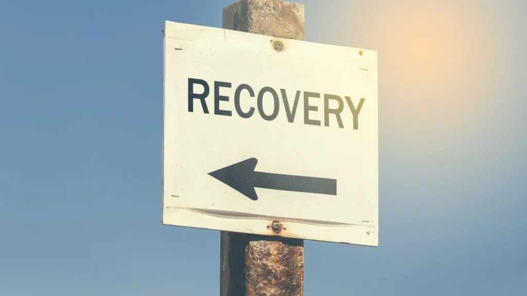 Outdoor signpost with an arrow pointing the way to addiction recovery