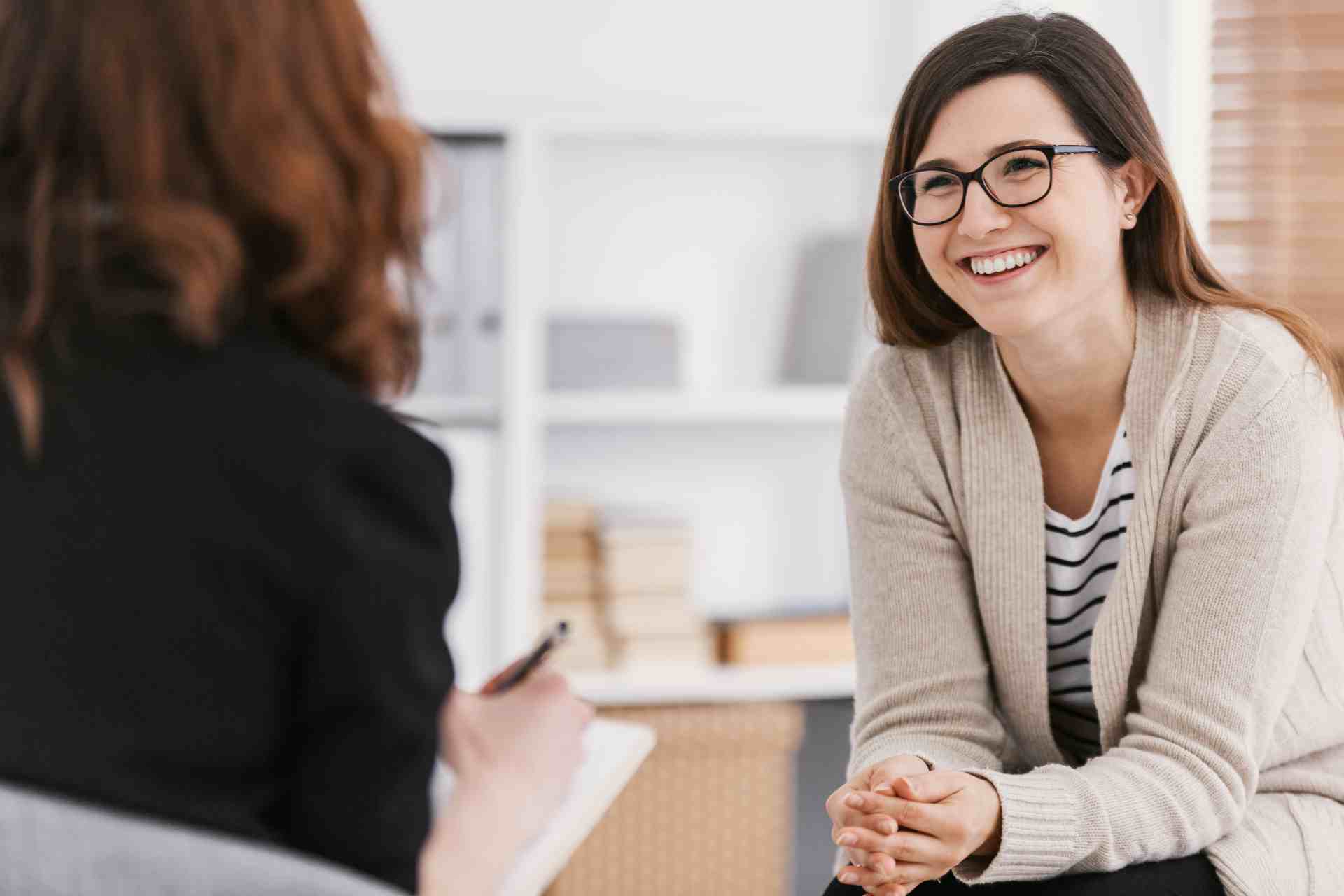 Woman smiling during a medical detox consultation at a treatment center.